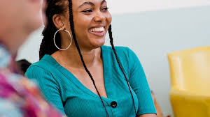 A smiling woman in a supportive community setting